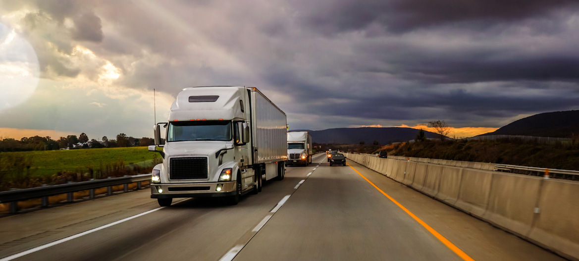 Beautiful and dramatic view of white trailer on highway at dawn