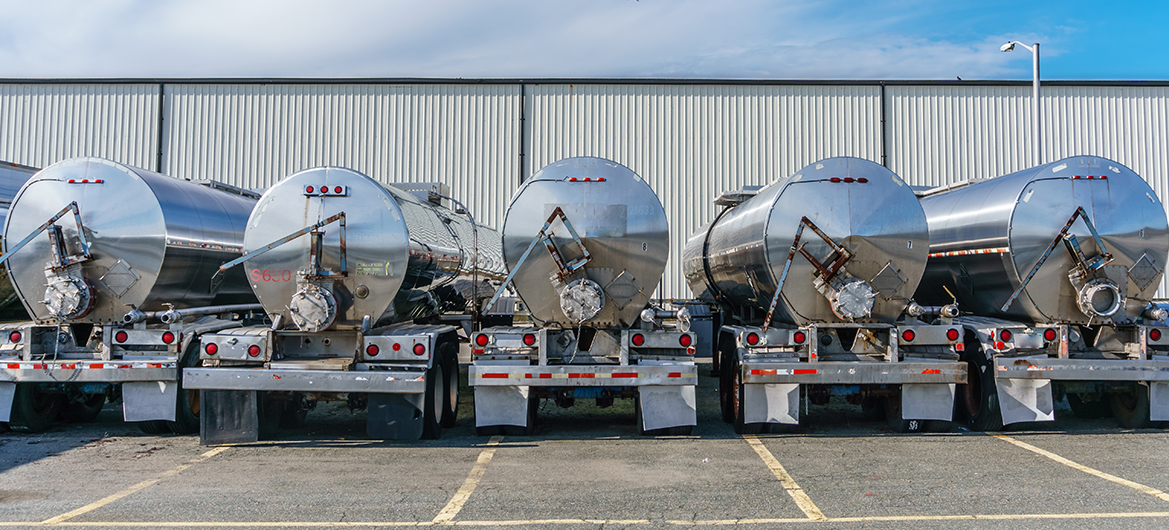 A group of trucks carrying hazardous materials is parked