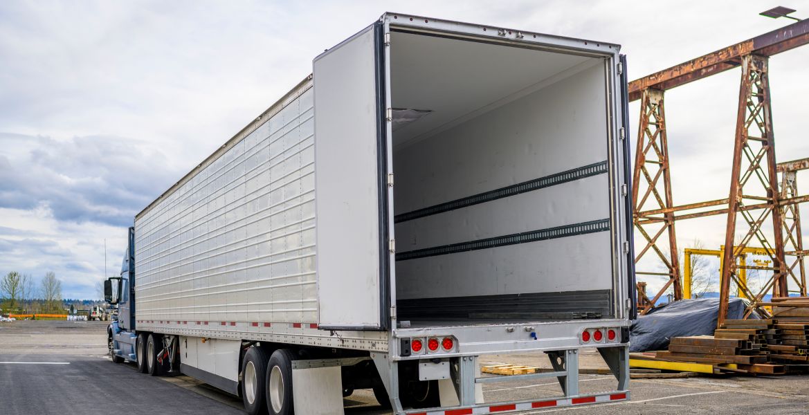 a semi truck with its door open in a parking lot