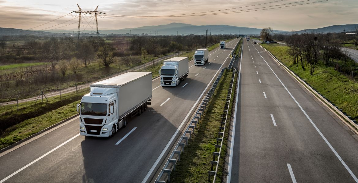 a couple of trucks driving down a highway