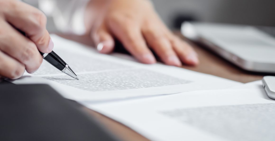 Insurance agent checking policy documents in office.