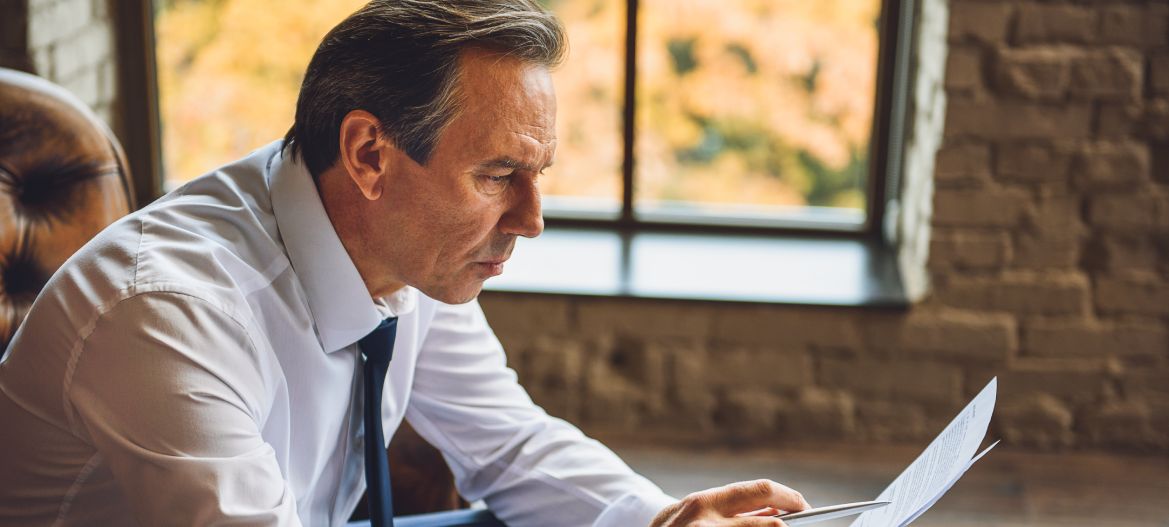 Middle aged businessman reading documents