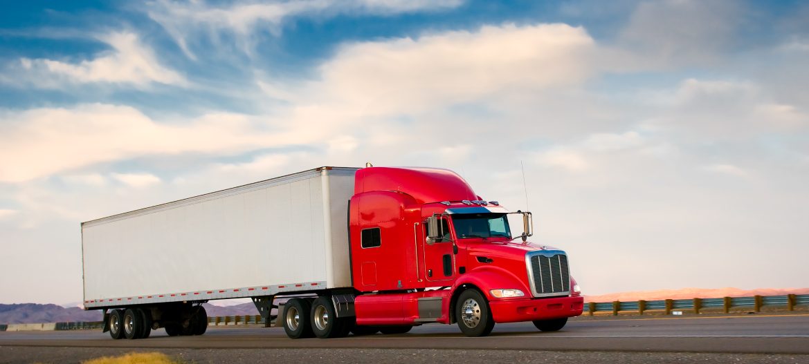 Red truck moving on a highway